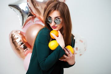 Portrait of smiling brunette girl in swimsuit in summer swimwear and sunglasses