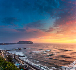 Fototapeta na wymiar Panoramic sunset cityscape of the beach and the highway in Lima, Peru