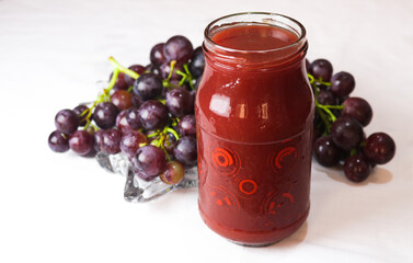 Jar of Grape jam with fresh summer food