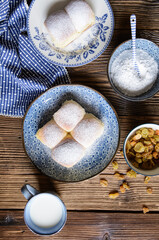 Sweet yeast buns stuffed with curd, raisins and studded with powdered sugar