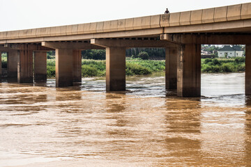River Kaduna  Bridge. A view of River Kaduna featuring the River Kaduna bridge with a passer-by atop it
