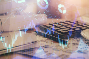 Double exposure of financial chart drawings and desk with open notebook background. Concept of forex market