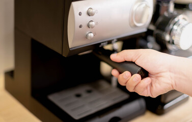 The female hand making the fresh coffee maker, Barista making coffee for prepare coffee to serve customers