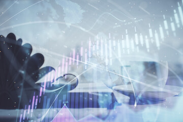 Double exposure of financial chart drawing and desktop with coffee and items on table background. Concept of forex market trading