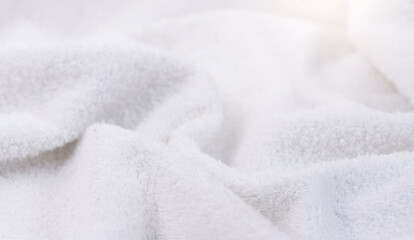 Towel texture closeup. Soft white cotton towel backdrop, fabric background. Terry cloth bath or beach towels. Soft fluffy Textile. Macro, texture  - obrazy, fototapety, plakaty