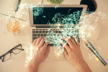 Double exposure of man's hands typing over computer keyboard and social network theme hologram drawing. Top view. People connection web concept.