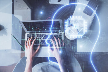 Double exposure of woman working on computer andhuman brain hologram drawing. Top View. Ai concept.