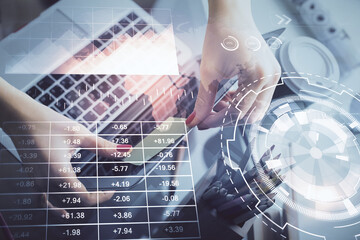 Double exposure of businesswoman hands typing on computer and financial graph hologram drawing. Stock market analysis concept.