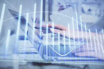 Multi exposure of woman hands typing on computer and financial graph hologram drawing. Stock market analysis concept.
