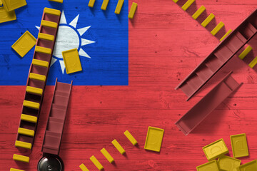Taiwan flag with national background with dominoes on wooden table. Top view. Concept of game.