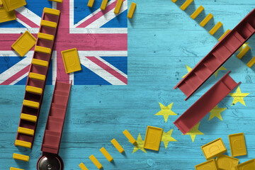 Tuvalu flag with national background with dominoes on wooden table. Top view. Concept of game.