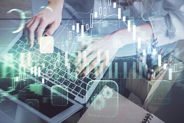 Double exposure of woman hands typing on computer and forex chart hologram drawing. Stock market invest concept.