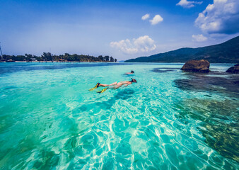 couple snorkeling in clear blue sea
