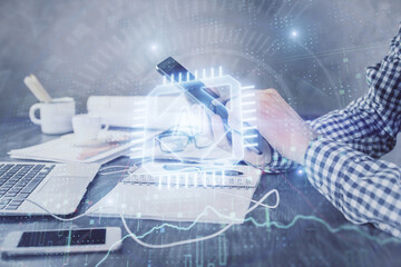 Double exposure of man's hand holding and using a digital device and data theme hologram drawing. Technology concept.