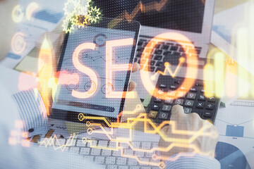 Multi exposure of man's hands holding and using a digital device and seo drawing. search optimization concept.