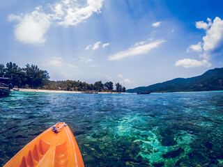  kayaking in crystal clear tropical waters - kayak heading to isolated beach in Ko Tarutao national park