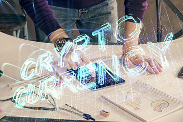 Double exposure of man's hands holding and using a phone and crypto currency blockchain theme...