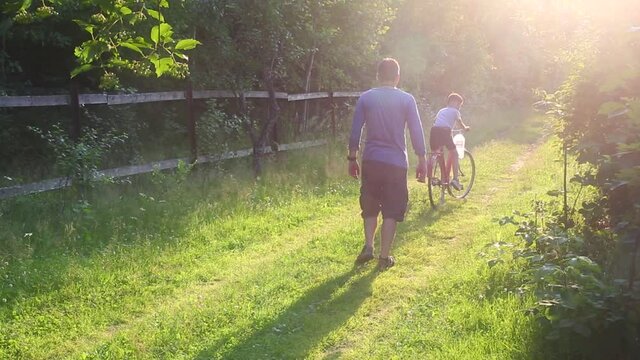 Father halps to his son biking