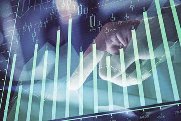 Multi exposure of man's hands holding and using a phone and financial chart drawing. Market analysis concept.