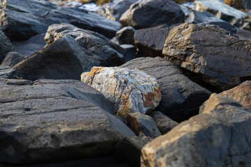 tuff quarried volcanic rock surrounded by darker rocks
