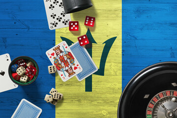 Barbados casino theme. Aces in poker game, cards and chips on red table with national wooden flag background. Gambling and betting.
