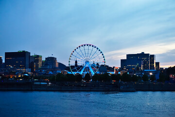 Montreal Grand Ferris Wheel in Old Port at the twilight blue hour. Foreground is Saint Laurent...