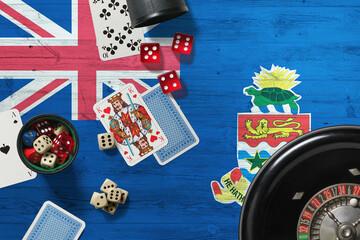 Cayman Islands casino theme. Aces in poker game, cards and chips on red table with national wooden flag background. Gambling and betting.