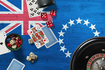 Cook Islands casino theme. Aces in poker game, cards and chips on red table with national wooden flag background. Gambling and betting.