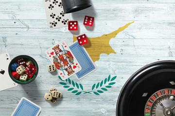 Cyprus casino theme. Aces in poker game, cards and chips on red table with national wooden flag background. Gambling and betting.