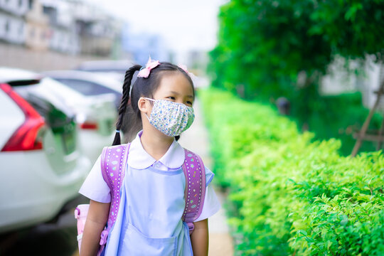 Thai Girl Student Wearing A Mask Against Coronavirus Before Going To School