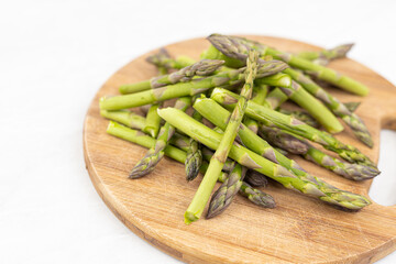 Cooked asparagus on the wooden board