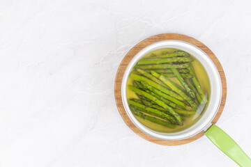 Top view of Cooked asparagus in the bowl