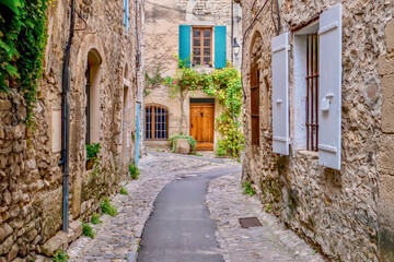 A quaint narrow lane running through the medieval area of Vaison la Romaine, a village in the...