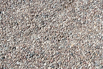 Gravel texture Small stones, little rocks, pebbles in many shades of grey, white, brown, pink colour in close-up. Crushed granite texture. Road made of stones from river or lake Small rock background