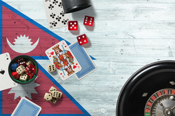 Nepal casino theme. Aces in poker game, cards and chips on red table with national wooden flag background. Gambling and betting.