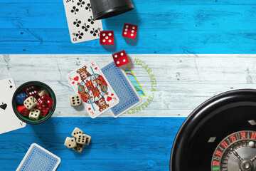 Nicaragua casino theme. Aces in poker game, cards and chips on red table with national wooden flag background. Gambling and betting.