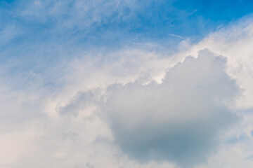Fototapeta na wymiar Layers of cirrocumulus and cirrus clouds in upper atmosphere in blue sky.