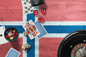 Norway casino theme. Aces in poker game, cards and chips on red table with national wooden flag background. Gambling and betting.