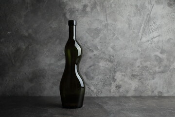 Wine bottle on a concrete background. Free space for inscription.