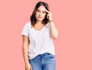 Young beautiful caucasian woman wearing casual white tshirt worried and stressed about a problem with hand on forehead, nervous and anxious for crisis