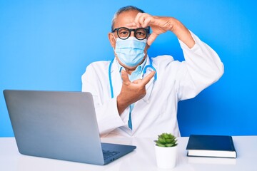 Senior handsome man with gray hair wearing doctor uniform and medical mask smiling making frame with hands and fingers with happy face. creativity and photography concept.