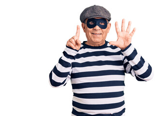 Senior handsome man wearing burglar mask and t-shirt showing and pointing up with fingers number six while smiling confident and happy.
