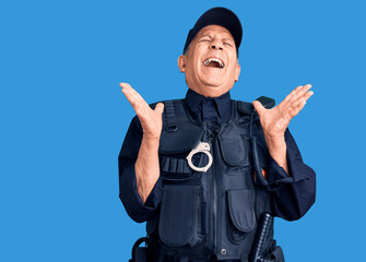 Senior handsome man wearing police uniform celebrating mad and crazy for success with arms raised and closed eyes screaming excited. winner concept