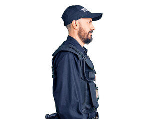 Young handsome man wearing police uniform looking to side, relax profile pose with natural face and confident smile.