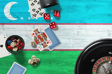 Uzbekistan casino theme. Aces in poker game, cards and chips on red table with national wooden flag background. Gambling and betting.