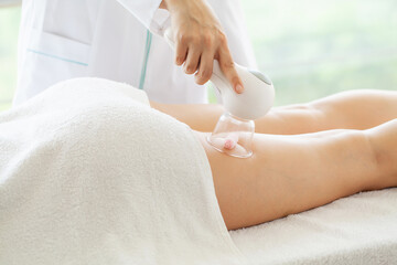 Obraz na płótnie Canvas Woman getting LPG massage for skin care in beauty studio