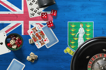 British Virgin Islands casino theme. Aces in poker game, cards and chips on red table with national wooden flag background. Gambling and betting.