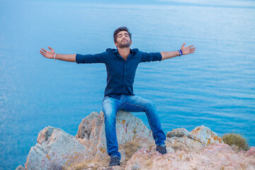 Man smiling looking up to blue sky celebrating freedom