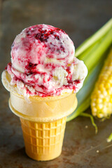Sweet corn and blackberry ice cream in a cone