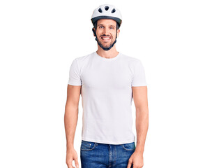Young handsome man wearing bike helmet with a happy and cool smile on face. lucky person.